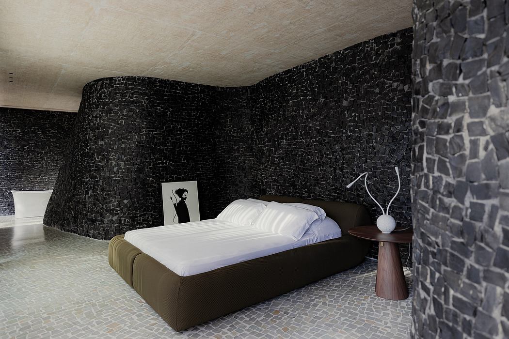 Black mosaic walls, minimalist bed, and wooden side table create a sleek, modern aesthetic.