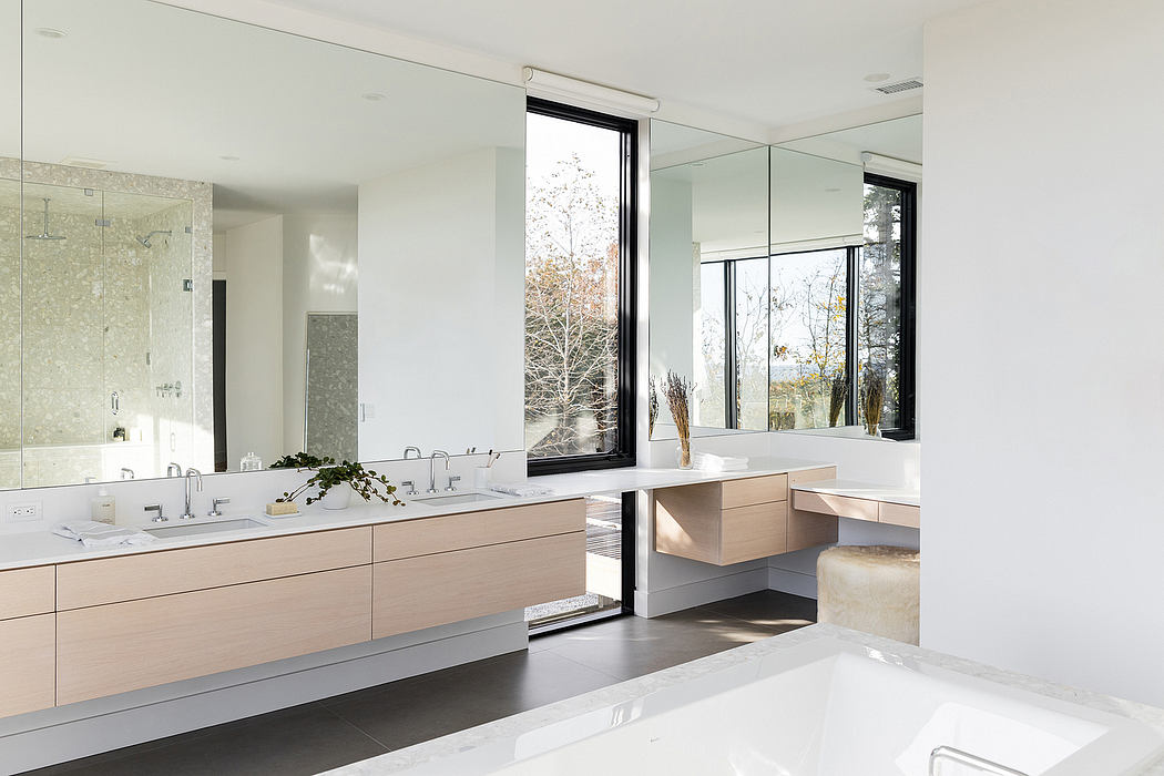 Spacious modern bathroom with natural lighting, clean lines, and minimalist cabinetry.
