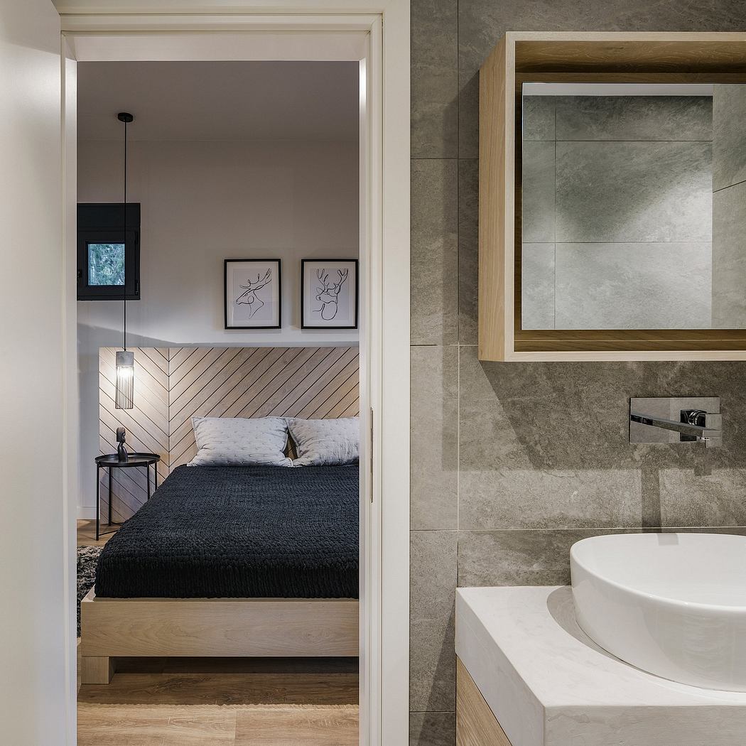Minimalist bedroom with gray tiled walls, wooden furniture, and a modern sink vanity.