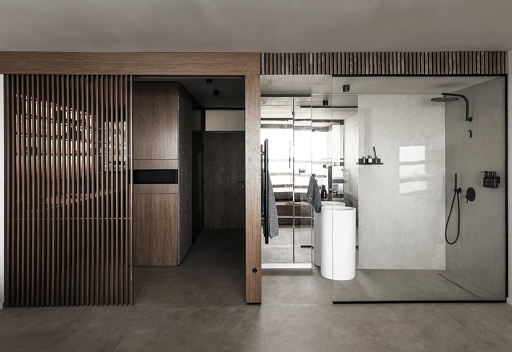 Minimalist modern interior with wood slat wall, white vessel sink, and shower fixture.
