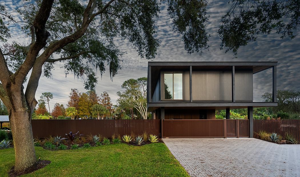 Modern two-story home with mixed materials, expansive windows, and landscaped surroundings.