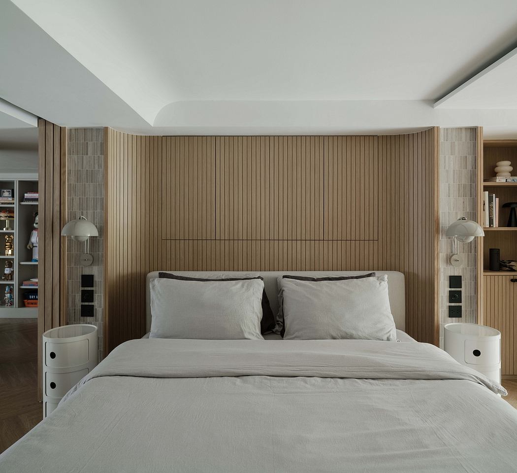 Warm-toned wooden paneled walls and built-in shelving create a serene bedroom.