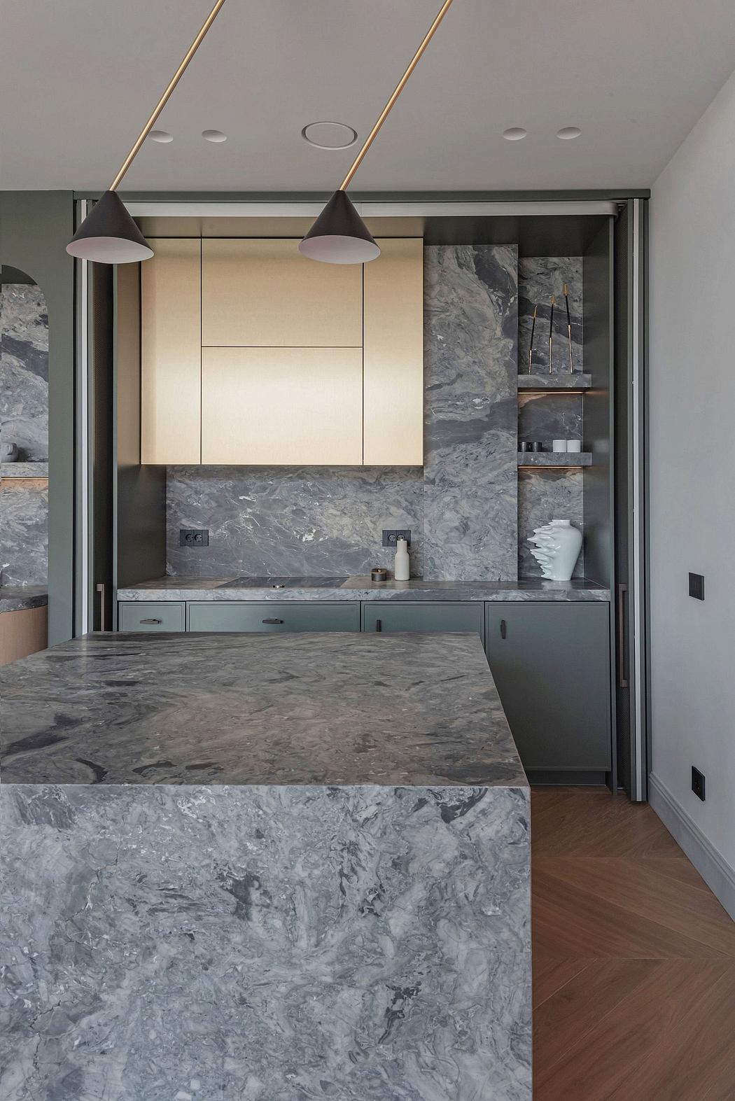 A contemporary kitchen with sleek gray marble countertops, minimalist cabinetry, and pendant lighting.