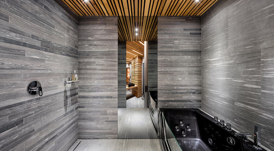A sleek, modern bathroom with wood-paneled ceilings and textured stone walls creating a luxurious ambiance.