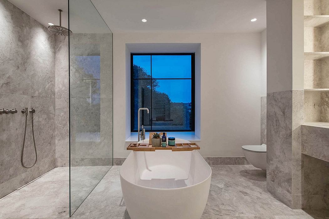 A luxurious bathroom with a freestanding bathtub, contemporary fixtures, and a stunning view.