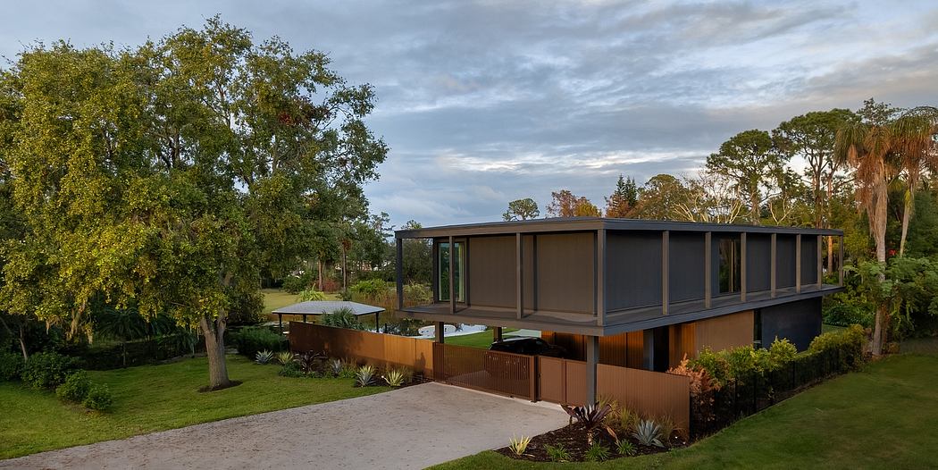 A modern, minimalist house with large windows, wood accents, and lush landscaping.