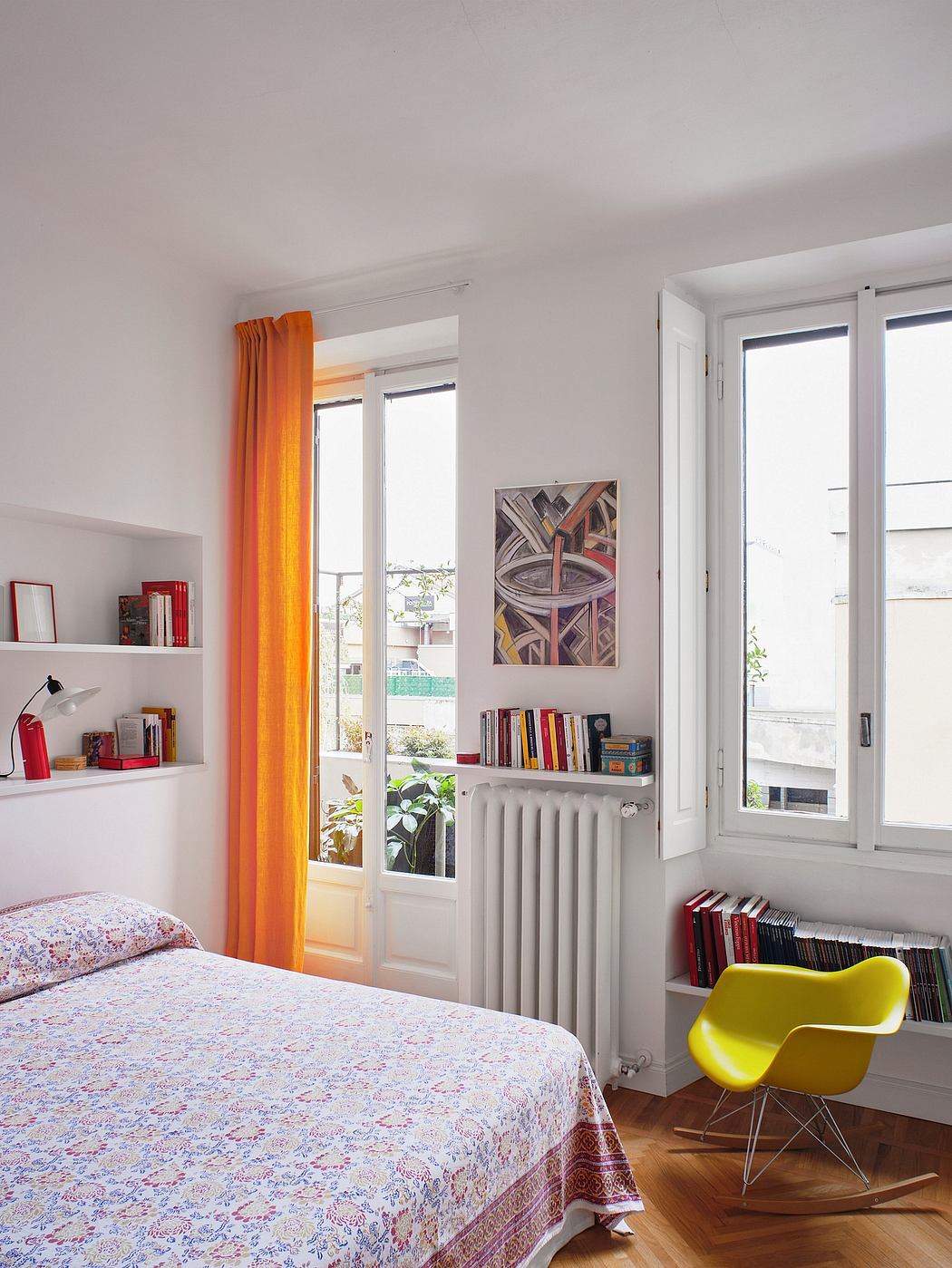 Cozy bedroom with colorful curtains, modern artwork, and eclectic furnishings.