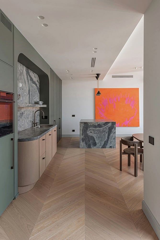 Sleek, modern kitchen design with contrasting materials and bold artwork.