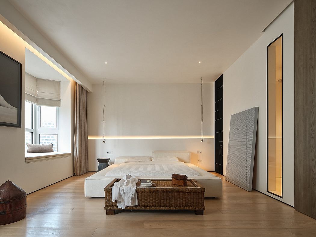 Spacious, modern bedroom with clean lines, warm lighting, and minimalist furniture.
