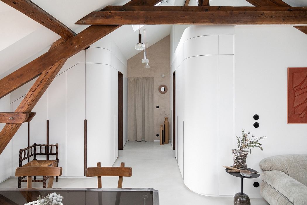 Rustic wooden beams, white walls, and minimal decor create a serene, modern space.