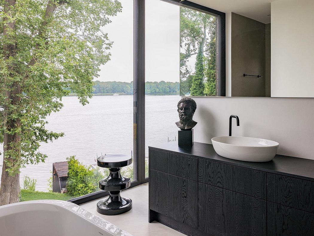 Sleek modern bathroom with expansive views of the lake through floor-to-ceiling windows.