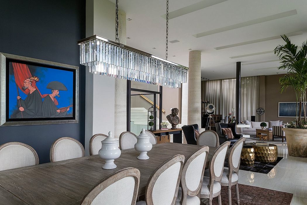 Striking modern dining room with large chandelier, artwork, and sleek furnishings.