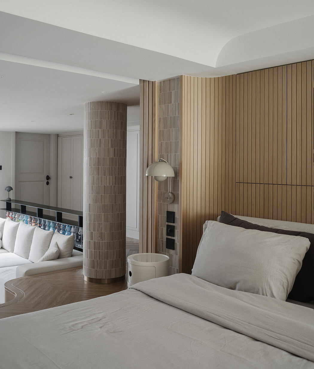 Sleek modern bedroom with wood-paneled wall, minimal furnishings, and recessed lighting.