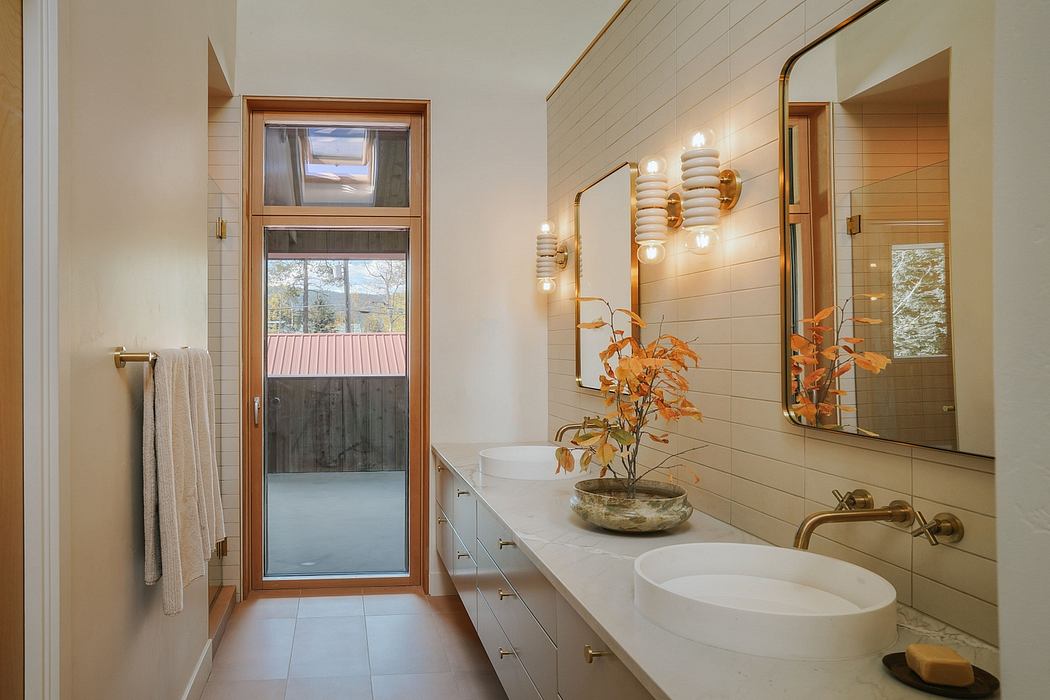 Spacious bathroom with wood-framed windows, modern vanity, and stylish lighting.