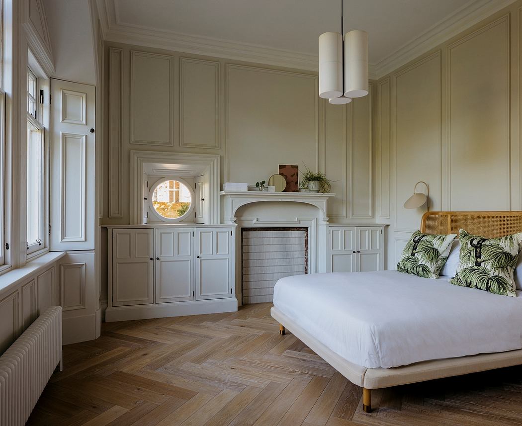 Elegant bedroom with intricate wainscoting, herringbone wood floors, and stylish lighting.