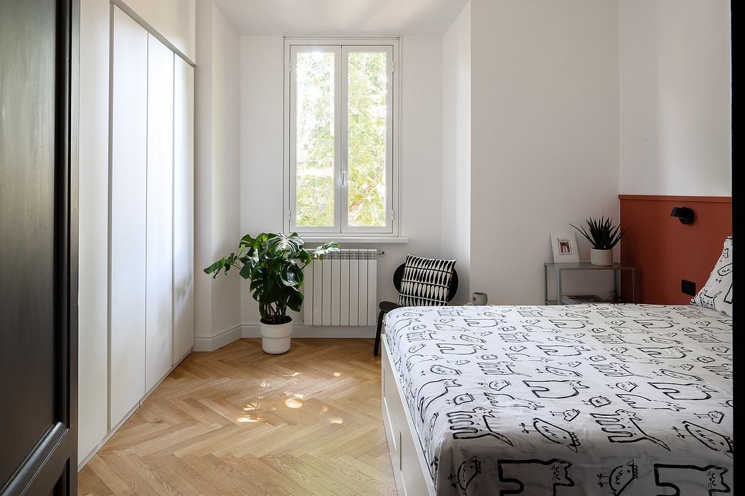 A modern bedroom with large windows, parquet flooring, and a vibrant plant decor.