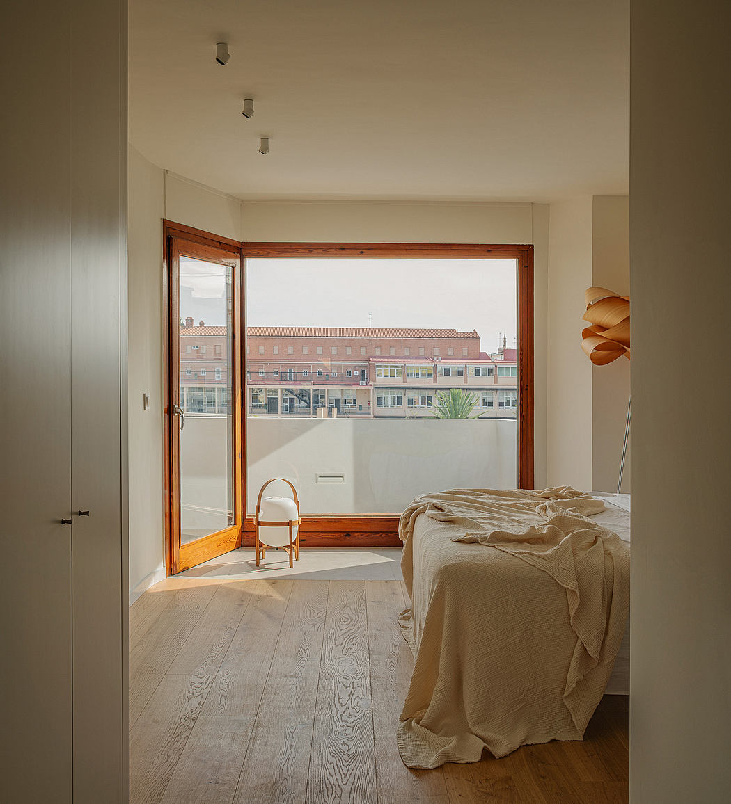 Serene bedroom with large wooden-framed windows overlooking the city skyline.