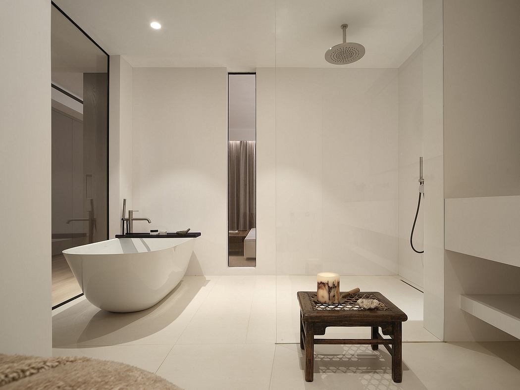 Luxurious modern bathroom with freestanding tub, minimalist decor, and overhead shower.