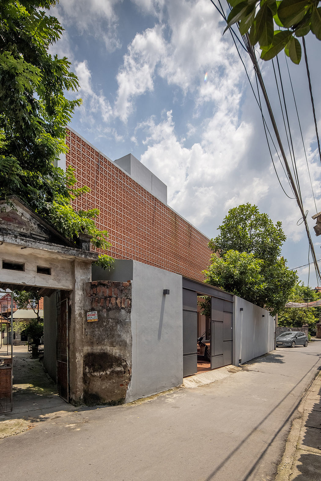 A modern, geometric building with a striking brick facade and contrasting gray panels.