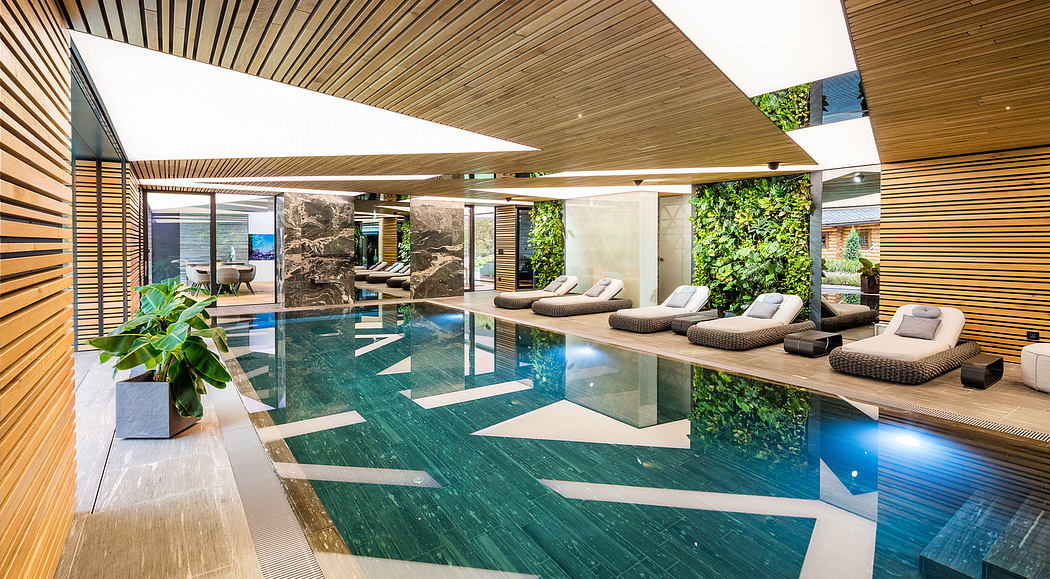 Sleek wooden ceiling, large pool, lounge chairs, lush greenery, and natural stone accents.