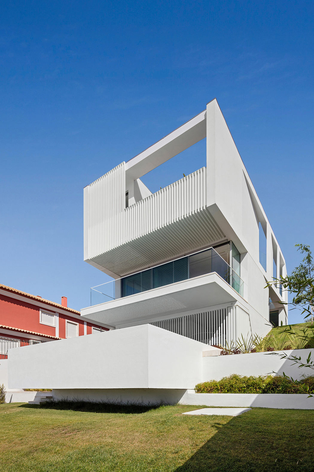 A modern, minimalist architectural design with clean lines, sharp angles, and a prominent balcony.