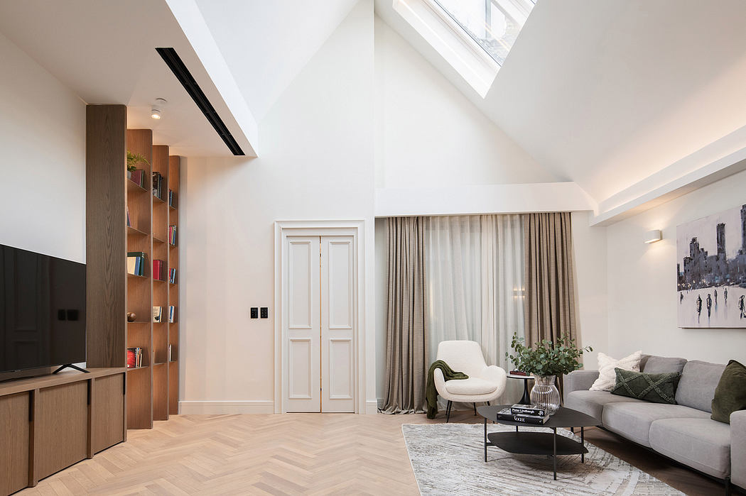 Bright, airy living room with slanted ceiling, built-in shelves, and gray sofa.