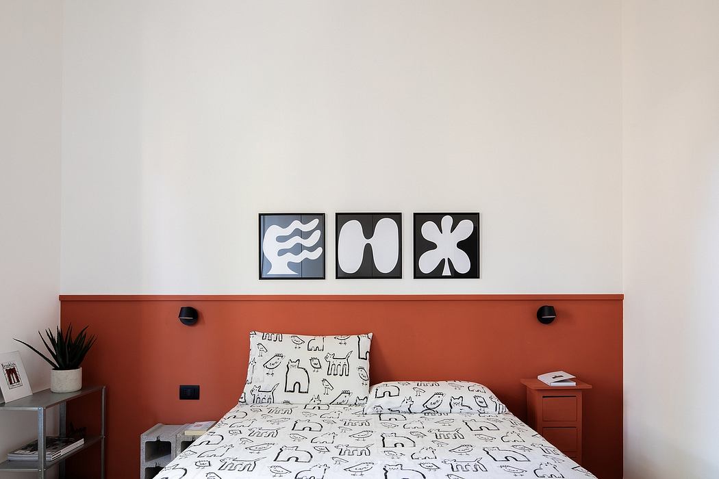 Minimalist bedroom design with abstract wall art and orange accented furniture.