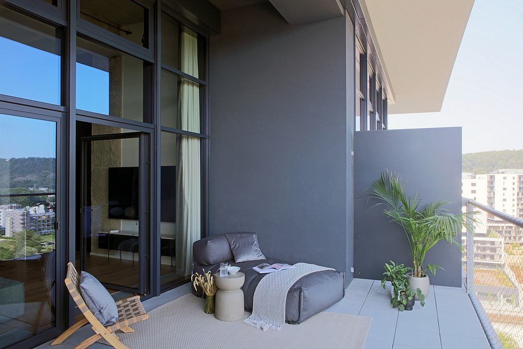 Sleek, modern apartment balcony with steel frames, lush greenery, and minimalist furnishings.