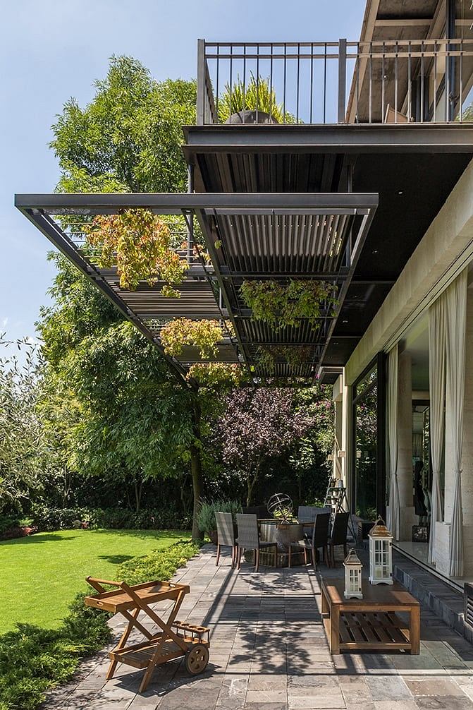 Elegant outdoor terrace with modern architectural elements and lush greenery.
