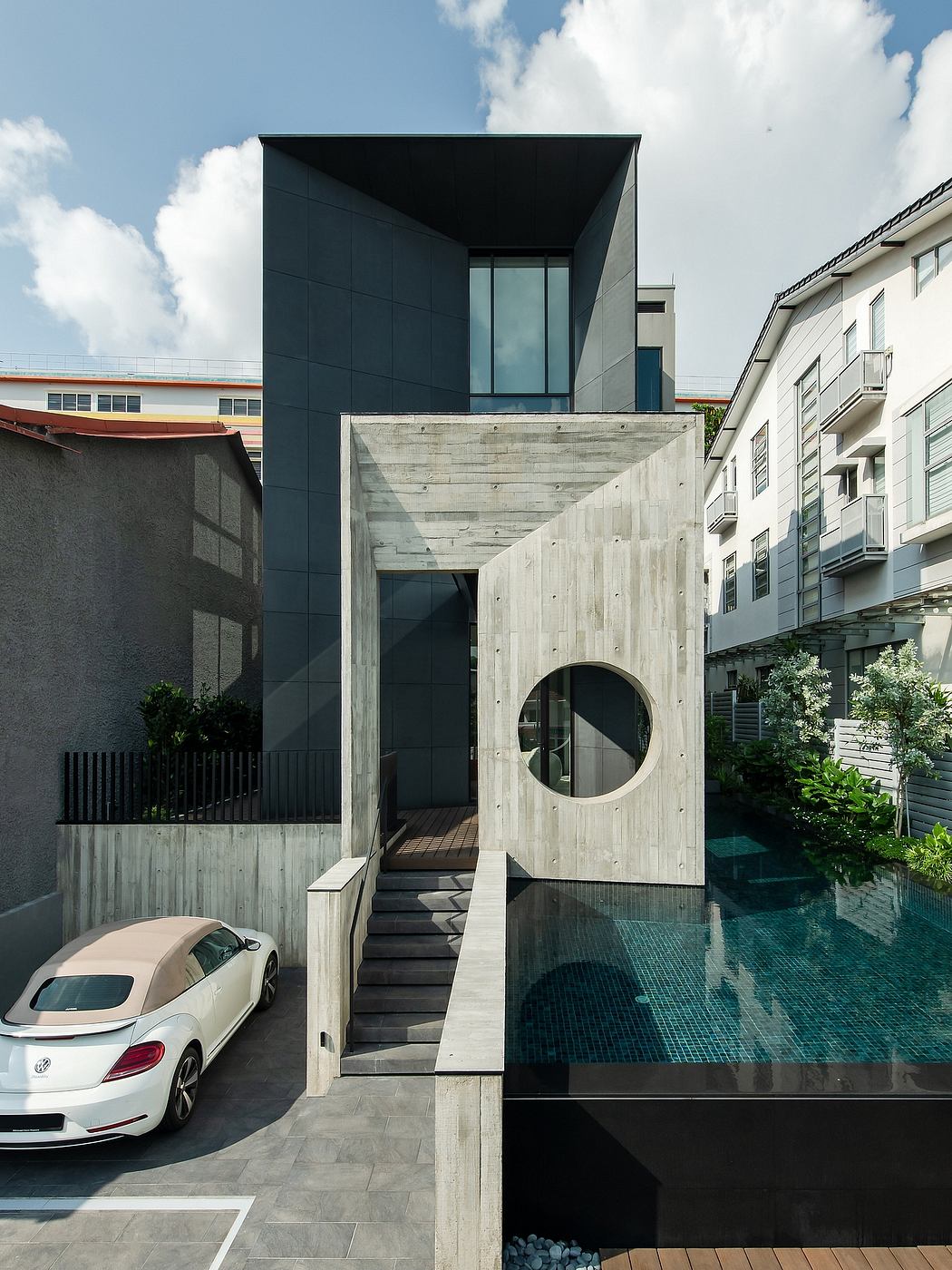 Striking modern architecture with concrete, glass, and bold geometric shapes.