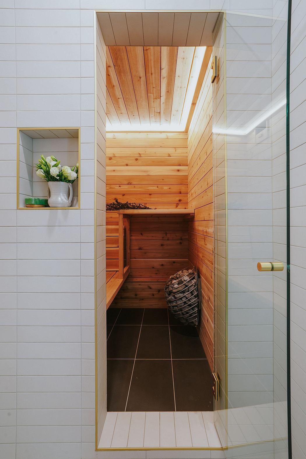 Wooden paneled ceiling and walls, built-in shelving, and tiled floor in a modern entryway.