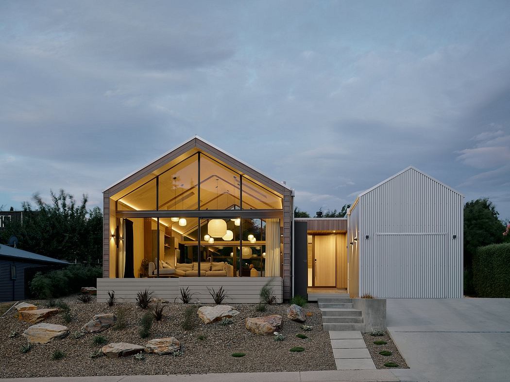Modern, open-concept home with glass walls, warm lighting, and natural materials.