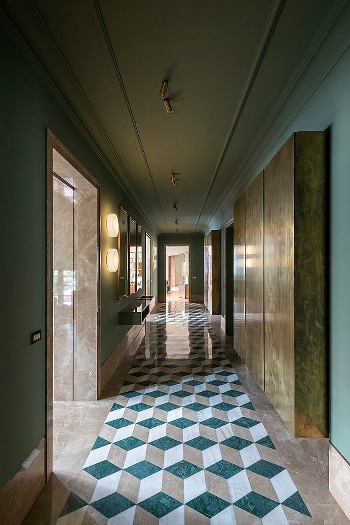 Sleek, modern hallway with geometric tile flooring and recessed lighting fixtures.