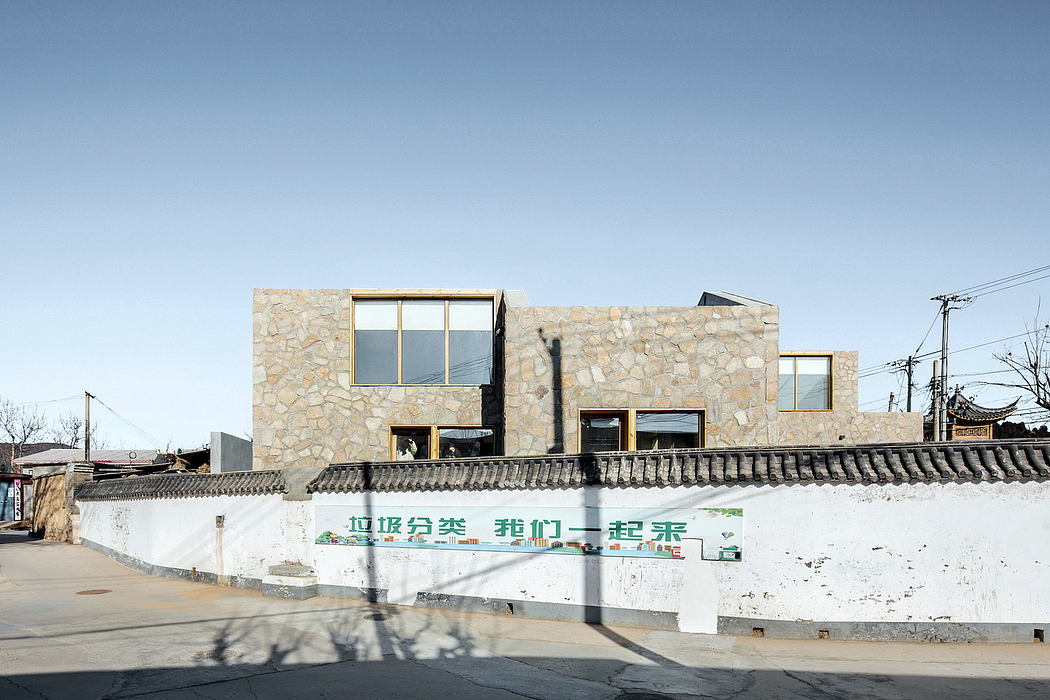 Modern stone-and-glass building with distinctive architectural features.