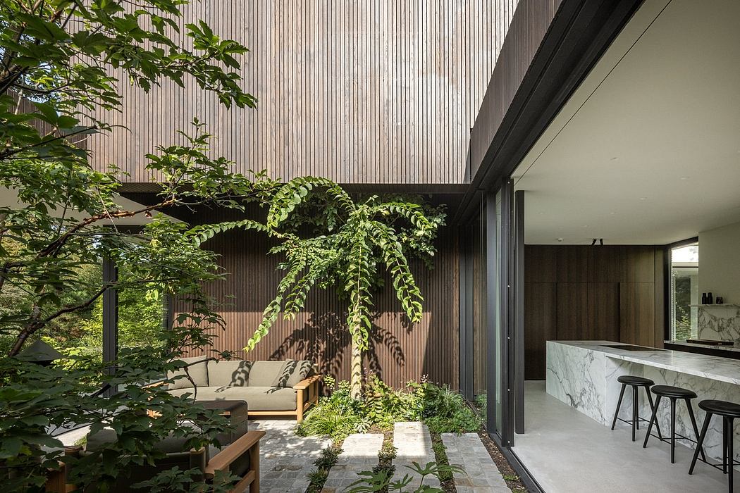 Vibrant indoor garden with lush greenery, modern architectural elements, and sleek kitchen.