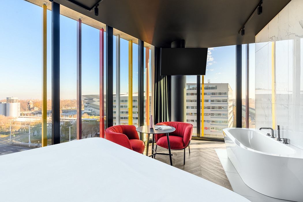 Bright, modern interior with vibrant red chairs, sleek bathroom, and panoramic city views.