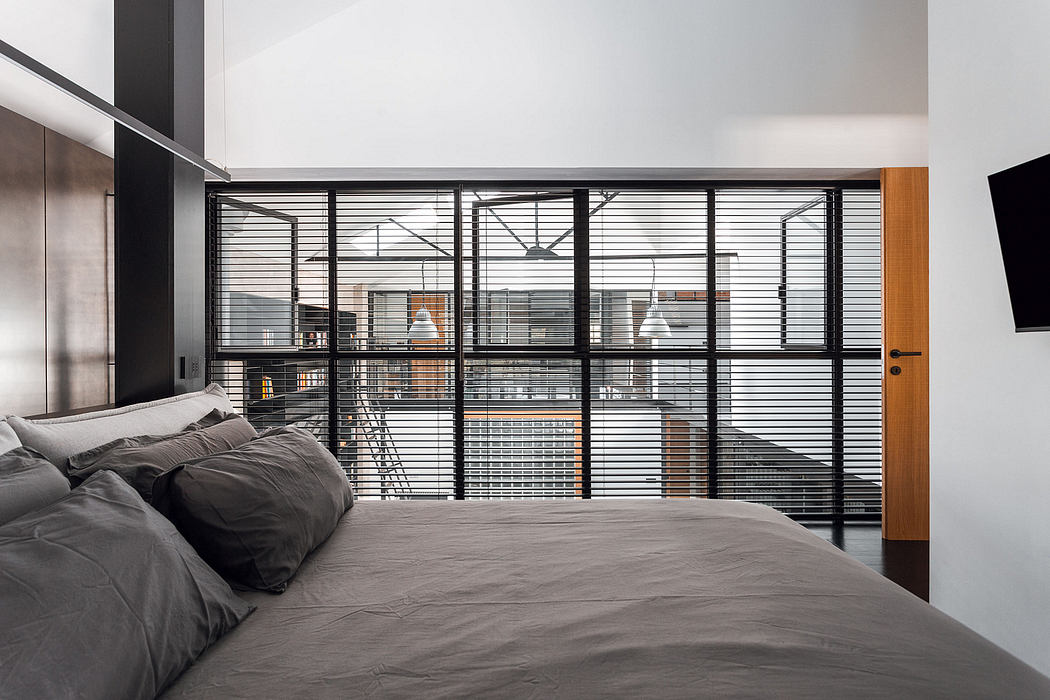 A modern, minimalist bedroom with sleek metal railings creating a visually striking feature.