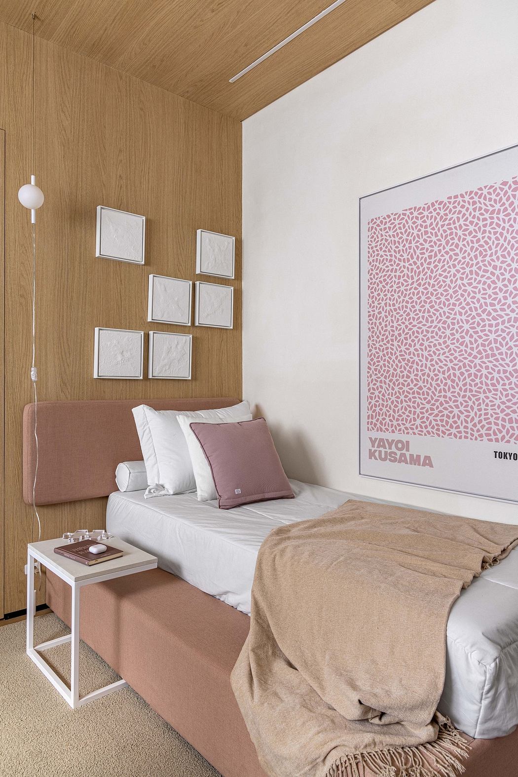 Warm, modern bedroom with wood-paneled walls, minimalist decor, and artistic wall print.