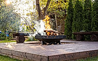 Outdoor Wooden Deck with Central Fire Pit and Rustic Benches