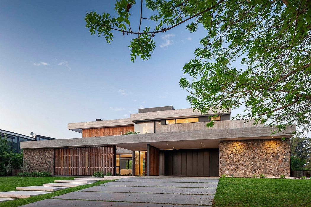 Impressive modern home with stone facade, wood accents, and overhanging roofline.