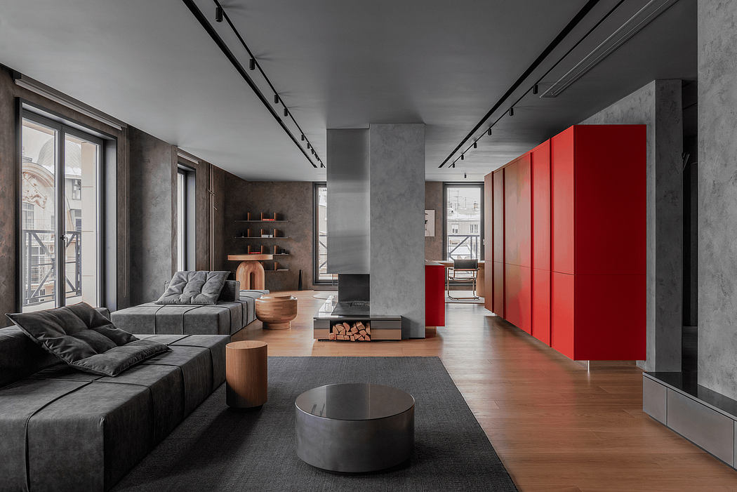 Striking industrial-inspired interior with bold red cabinetry, concrete walls, and sleek furnishings.
