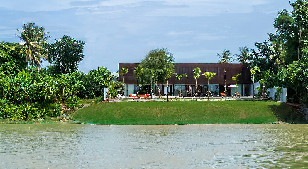 Tropical resort with modern architecture and lush green surroundings.