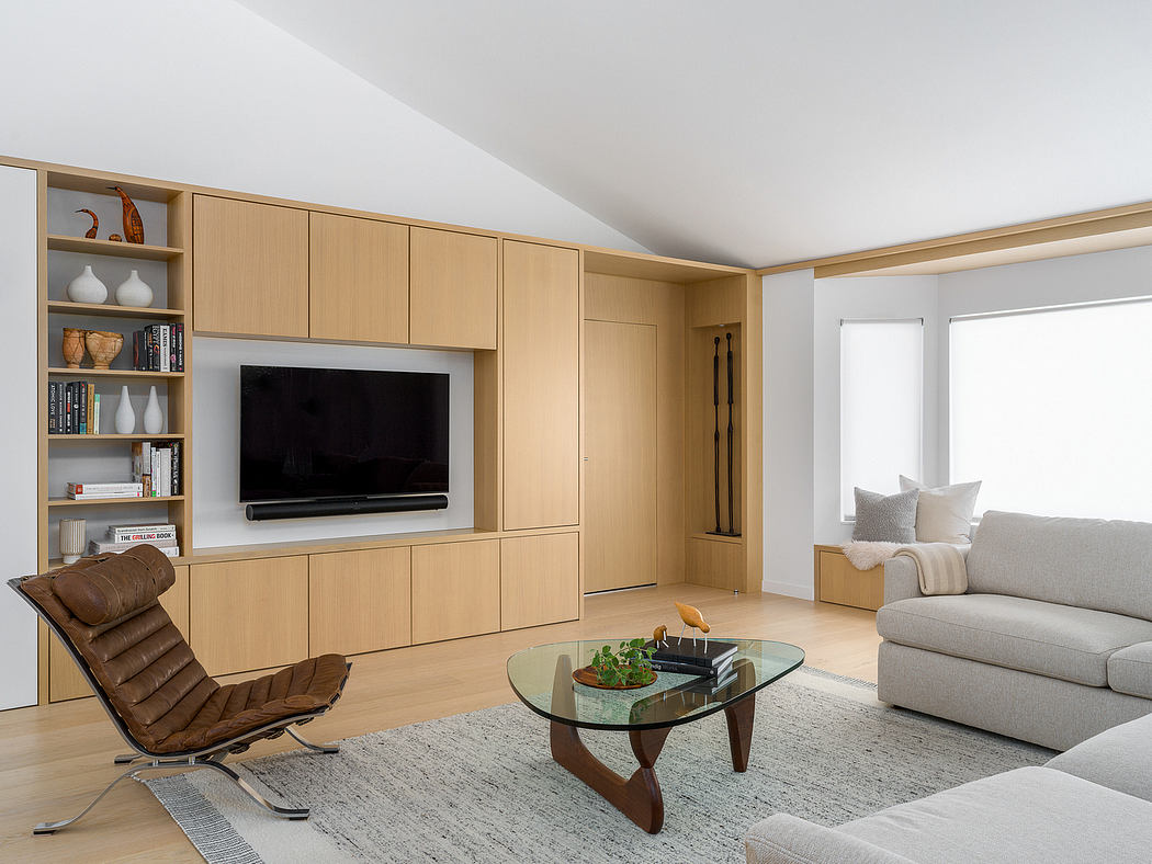 This living room features a sleek, contemporary built-in cabinetry system with a TV, shelves, and ample storage.