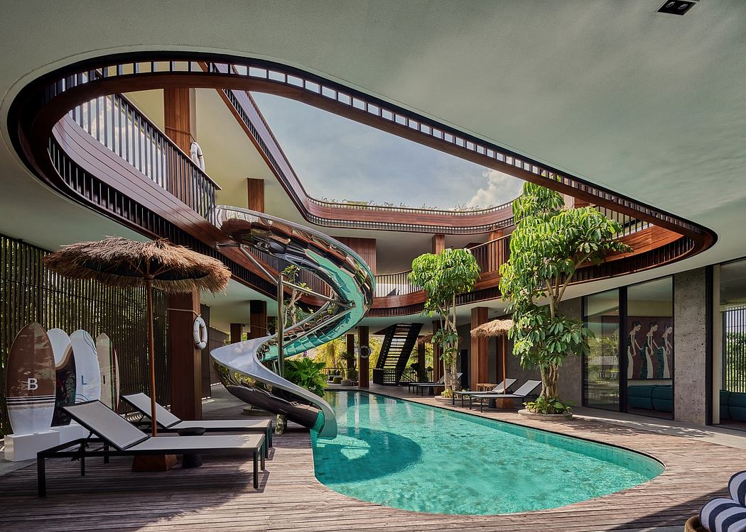 Impressive tropical-inspired resort design with curved wood accents, swimming pool, and slides.