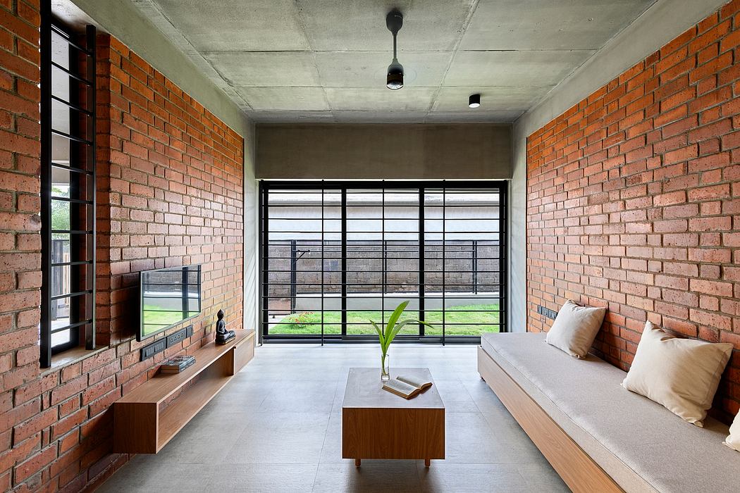 Minimalist living room with brick walls, concrete ceiling, and sleek wooden furniture.