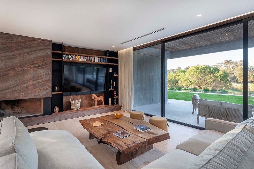 Spacious living room with large windows, rustic wood furniture, and modern design elements.