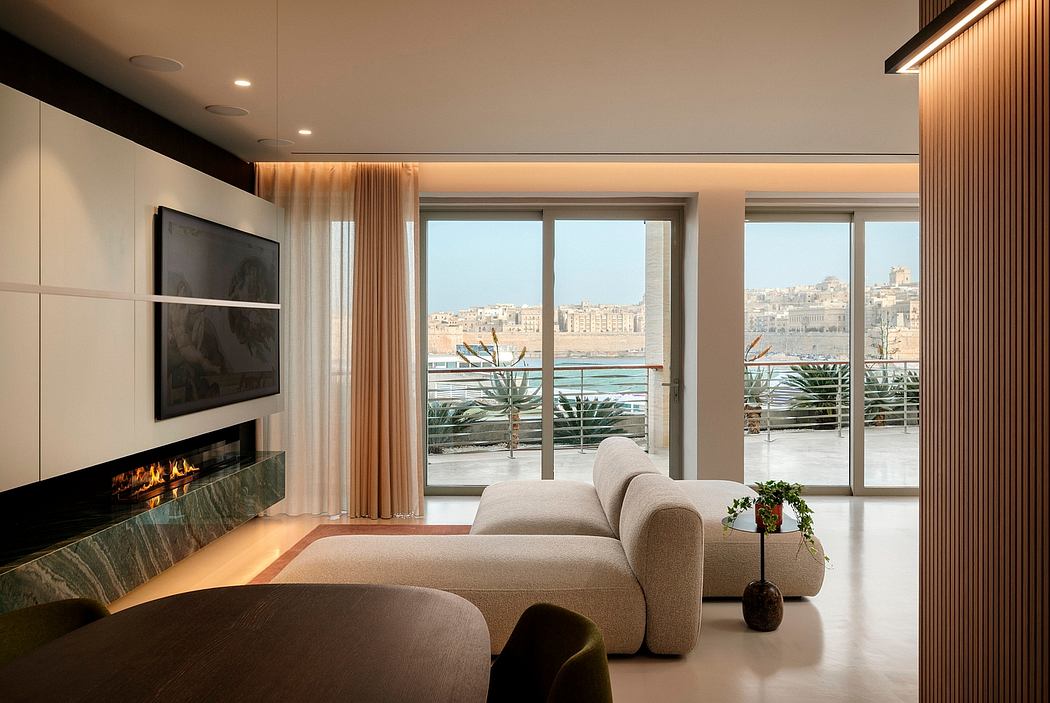 A modern, spacious living room with large windows, a fireplace, and a cozy sectional sofa.