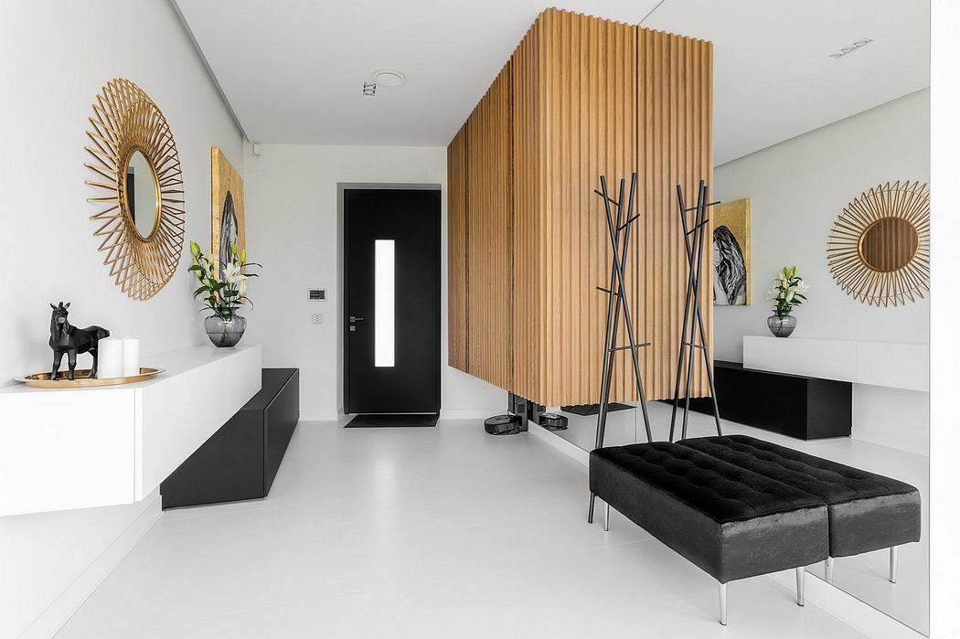 Minimalist interior with wooden accent wall, sleek black furniture, and decorative mirrors.