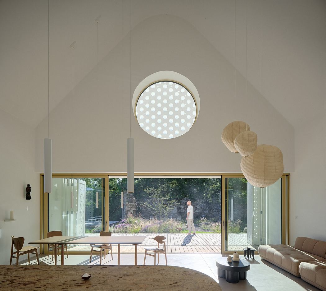 Sleek interior design with modern lighting fixtures, wood furnishings, and a view of the outdoor landscape.