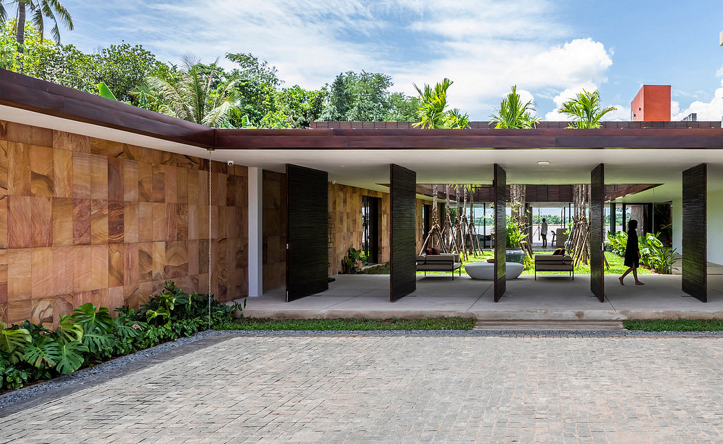 A modern tropical home with a lush, open-plan design and rich wood accents.